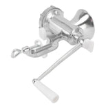 Manual meat grinder mincing beef on a kitchen bench