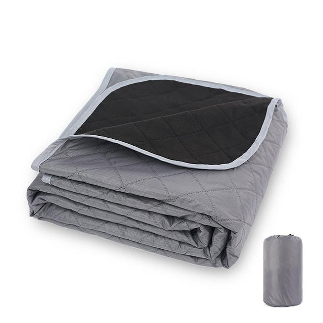 Windermere fleece picnic blanket in grey spread out on grass with a soft fleece top and water resistant polyester backing
