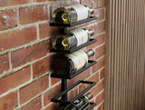 Matte black metal wall mounted wine rack holding 10 bottles