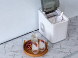 Ice maker lid open showing the ice basket full of bullet shaped cubes