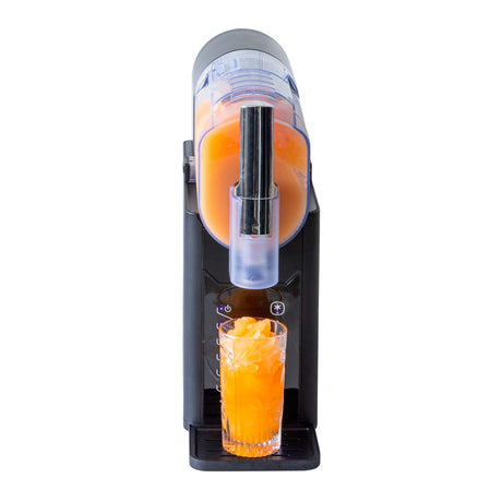 Frozen slushie being poured from the machine into a tall glass