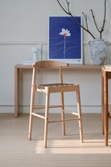 Aspendale natural oak counter stool with woven leather seat at a kitchen island