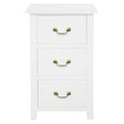 Ballina white solid mahogany three drawer bedside table with brass handles in a classic bedroom