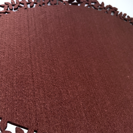 Brown leaf edge felt placemat on table