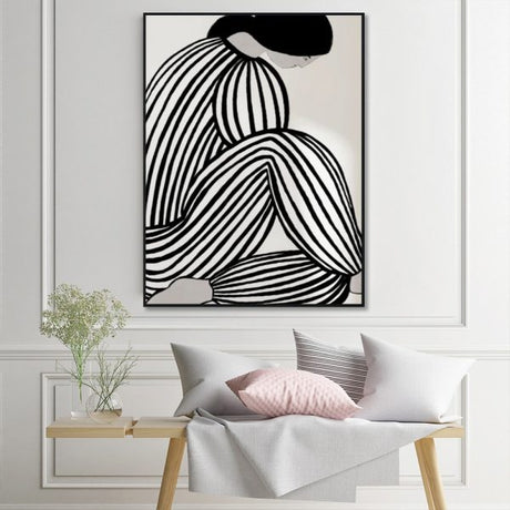 Mid century figure framed canvas styled on a wall in a modern living space