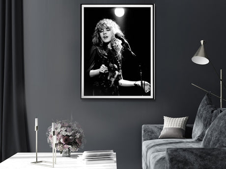 Black framed concert canvas print styled above a lounge room sofa