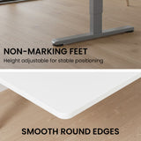 Turner white electric standing desk with silver frame in a home office
