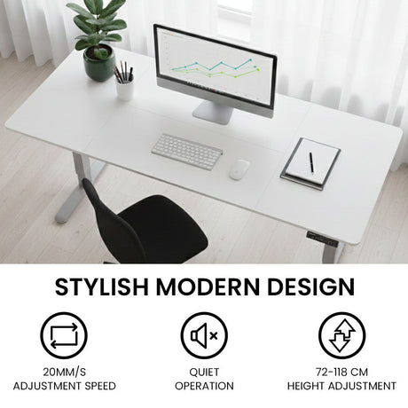 Turner white electric standing desk with silver frame in a home office