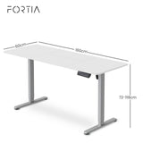 Turner white electric standing desk with silver frame in a home office