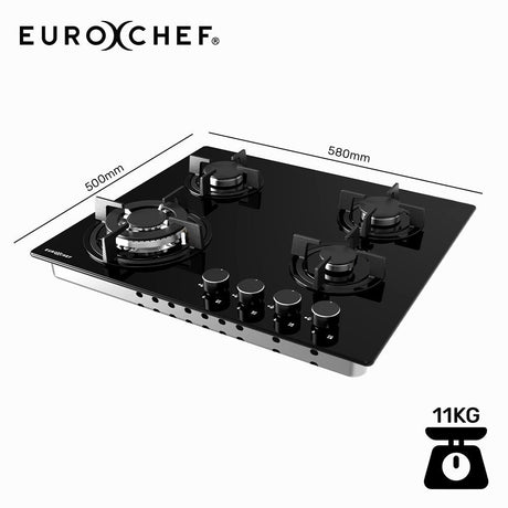 Cast iron trivets lifted off the black tempered glass gas cooktop for cleaning