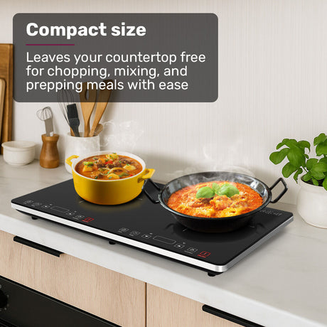 Portable induction cooktop on a benchtop with a saucepan on one zone