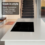 Induction cooktop installed in a kitchen benchtop with a pot on the left front zone