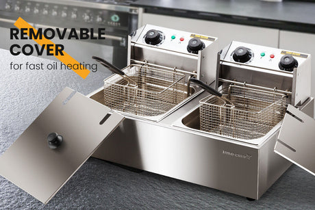 Hinged oil heating plate lifted clear of one fryer tank