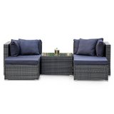 Four seat grey modular rattan outdoor lounge setting with ottomans and table