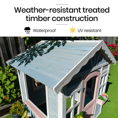 Light blue wooden cubby house in a backyard