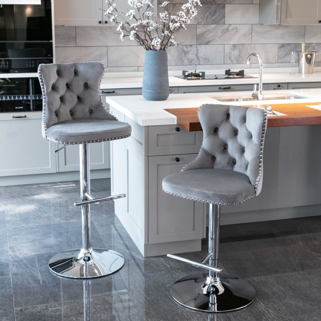 Pair of velvet studded bar stools styled at white kitchen island — Allure Home Collections