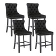 Ranelagh black velvet bar stool with silver stud trim and wooden legs in a dining room