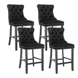 Ranelagh black velvet bar stool with silver stud trim and wooden legs in a dining room