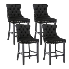 Ranelagh black velvet bar stool with silver stud trim and wooden legs in a dining room