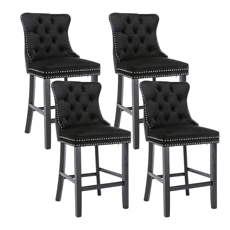 Ranelagh black velvet bar stool with silver stud trim and wooden legs in a dining room