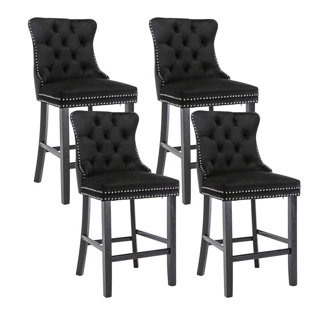 Ranelagh black velvet bar stool with silver stud trim and wooden legs in a dining room