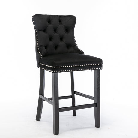 Ranelagh black velvet bar stool with silver stud trim and wooden legs in a dining room