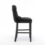 Ranelagh black velvet bar stool with silver stud trim and wooden legs in a dining room