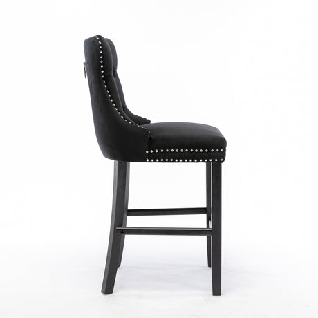 Ranelagh black velvet bar stool with silver stud trim and wooden legs in a dining room
