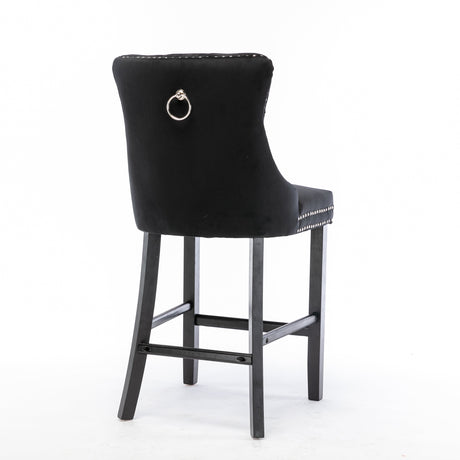 Ranelagh black velvet bar stool with silver stud trim and wooden legs in a dining room