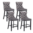 Waterways grey velvet bar stool with silver stud trim and wooden legs in a dining room