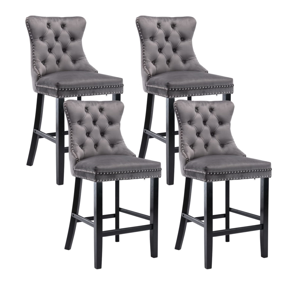 Waterways grey velvet bar stool with silver stud trim and wooden legs in a dining room