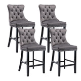 Waterways grey velvet bar stool with silver stud trim and wooden legs in a dining room