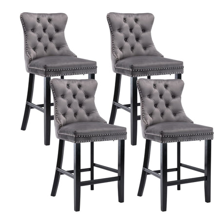 Waterways grey velvet bar stool with silver stud trim and wooden legs in a dining room