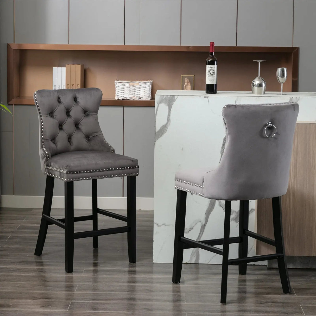 Waterways grey velvet bar stool with silver stud trim and wooden legs in a dining room