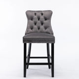Waterways grey velvet bar stool with silver stud trim and wooden legs in a dining room