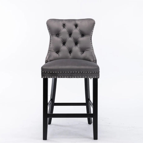 Waterways grey velvet bar stool with silver stud trim and wooden legs in a dining room