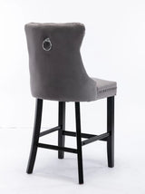 Waterways grey velvet bar stool with silver stud trim and wooden legs in a dining room