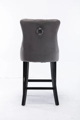 Waterways grey velvet bar stool with silver stud trim and wooden legs in a dining room