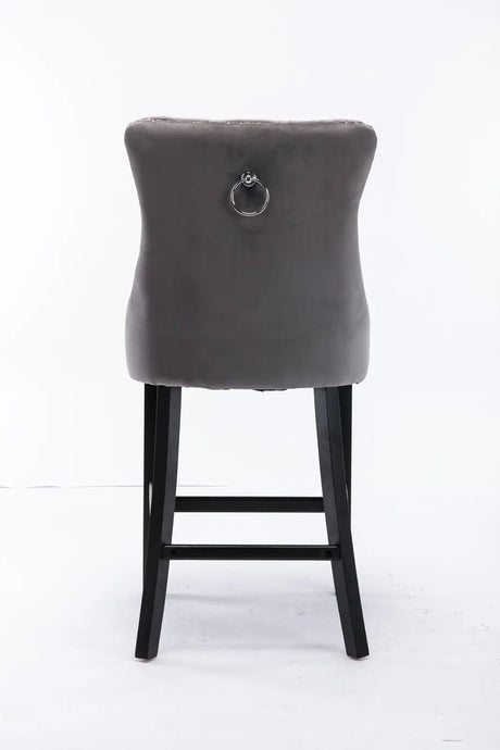 Waterways grey velvet bar stool with silver stud trim and wooden legs in a dining room