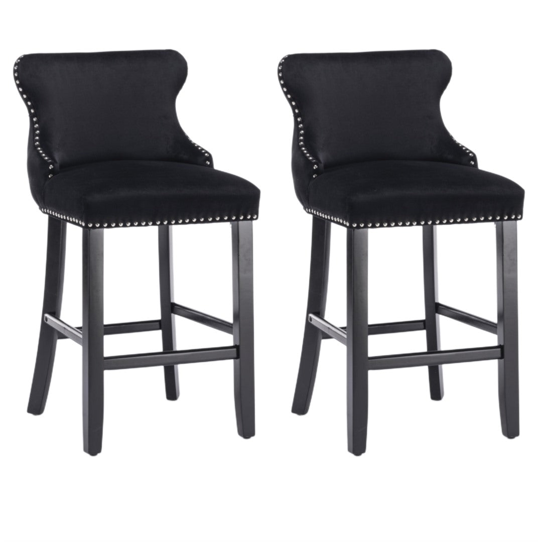 Silverleaves button tufted velvet bar stool black beside a kitchen island