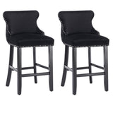 Silverleaves button tufted velvet bar stool black beside a kitchen island