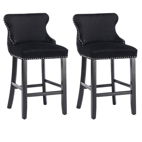 Silverleaves button tufted velvet bar stool black beside a kitchen island
