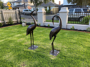 Two piece cast aluminium garden crane statue set in dark bronze
