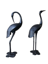 Male and female garden crane statues