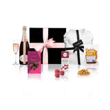 Sauternes champagne and pamper gift hamper with Chandon Rose, bathrobe, and gourmet treats in a black gift box with pink bow
