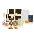 Cassis champagne and pamper gift hamper with Chandon, bathrobe, and self care treats in a black hamper box with cream bow