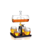 Bruenig 1L globe whisky decanter with sailboat detail, four glasses and wooden stand