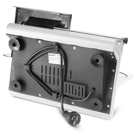 White electric food slicer cutting thin slices of meat