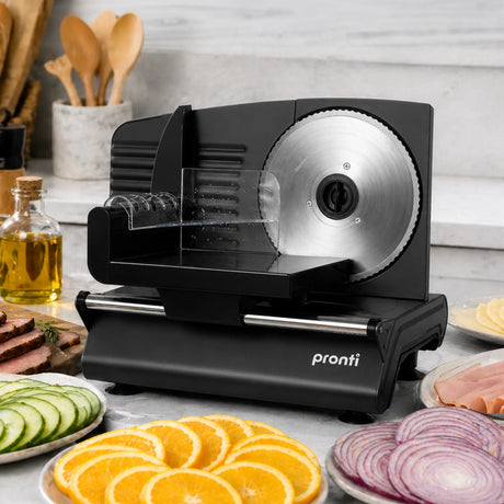 Black electric food slicer with sliced bread and vegetables