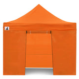 Zip up door panel of the orange gazebo tied open for guests to walk through